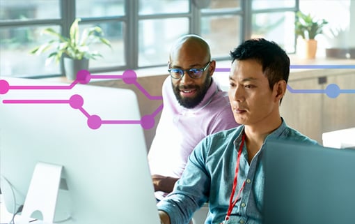 Two men at work looking at a computer screen together