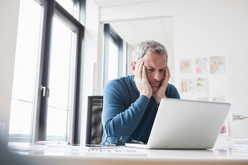 Homem olhando para a tela do computador portátil