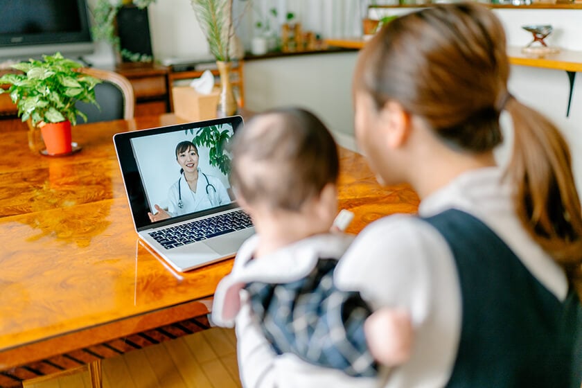 woman and baby doing video chat with doctor